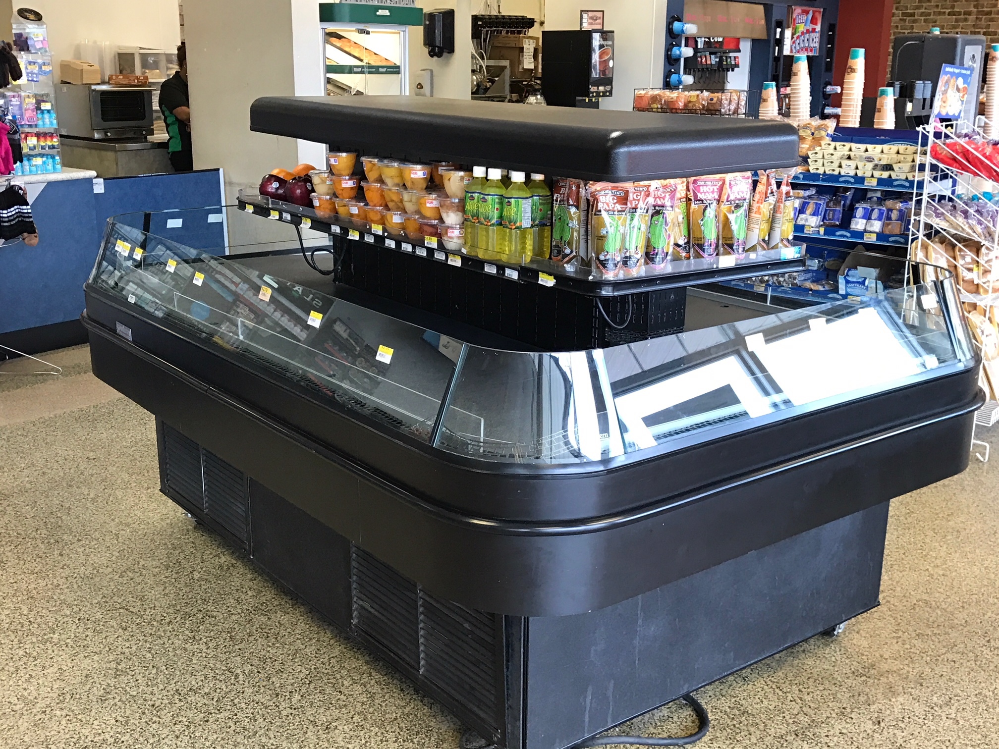 A large display case showcasing an assortment of diverse food items, highlighting their vibrant colors and appealing presentation.